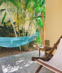 a hammock and a chair on a patio at Sonya Kohlanta in Ko Lanta
