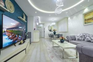 a living room with a couch and a tv at Apartment Boka View in Kotor