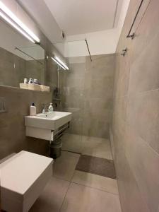 a bathroom with a sink and a toilet and a shower at Stylish Studios Apartment in the City Center with Air Conditioning in Budapest