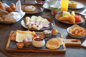 a table with a tray of different types of breakfast foods at Crowne Plaza Porto by IHG in Porto