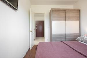 a bedroom with a large sliding glass door at Sea View Apartment Michelle near Osejava in Makarska