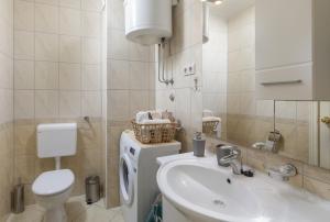a bathroom with a sink and a washing machine at Sea View Apartment Michelle near Osejava in Makarska +32 photos