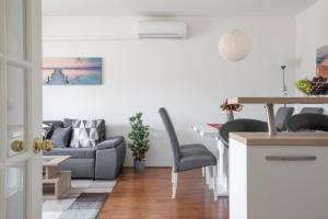 a living room with a couch and a table at Sea View Apartment Michelle near Osejava in Makarska