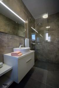 a bathroom with a sink and a shower at Villas Sabun - modern house with heated pool in Privlaka