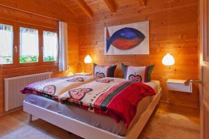 a bedroom with a bed in a wooden room at Blockhäuser in Stamsried in Stamsried