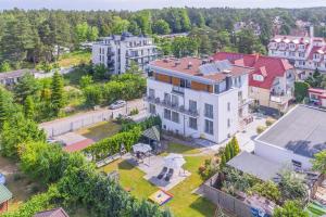 an aerial view of a large white house at Aparthotel Luna&Sol in Jastrzębia Góra