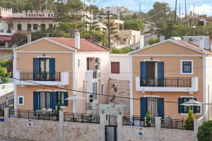 a group of houses with blue shutters on a hill at Cottage, Panormo in Panormos Rethymno