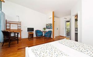 a bedroom with a bed and a desk and a table at Landgasthaus Ziegelscheune in Krippen