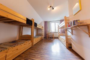 a room with two bunk beds and a desk at Schronisko PTTK Pasterka in Pasterka