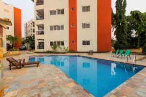 a swimming pool in front of a building at Accra Fine Suites - Holi Flats Airport Residential in Accra