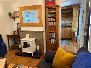 a living room with a couch and a fireplace at Rathjarney Gatelodge in Wexford