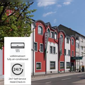 um edifício com um sinal em frente em Hotel Restaurant Wallner I contactless check-in em Sankt Valentin