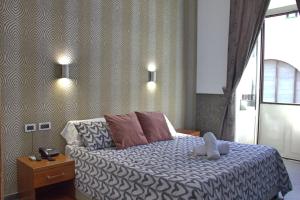 Postel nebo postele na pokoji v ubytování Hotel Ciao