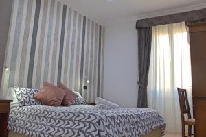 Postel nebo postele na pokoji v ubytování Hotel Ciao