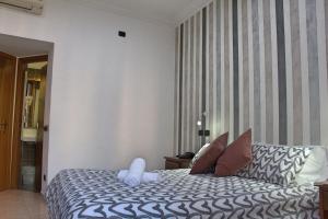 Postel nebo postele na pokoji v ubytování Hotel Ciao