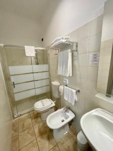 a bathroom with a white toilet and a sink at Best Quality Hotel Dock Milano in Turin