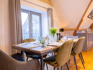 a dining room with a table and chairs at The Hayloft in Winchcombe