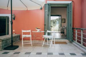 a room with two chairs and a table and a door at La Casa Rossa in Agios Nikitas +37 photos