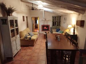 a living room with a table and a fireplace at Cortijo Aldamuz-VTAR102 in Oria