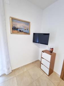 a room with a flat screen tv on a wall at Apartment Ane 2 in Tisno