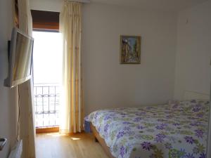 a bedroom with a bed and a window at Orahovac Bayview in Kotor