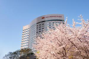 a building with a sign on top of it with trees at ANA Crowne Plaza Kanazawa by IHG in Kanazawa