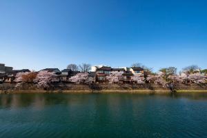 a large body of water with houses in the background at ANA Crowne Plaza Kanazawa by IHG in Kanazawa