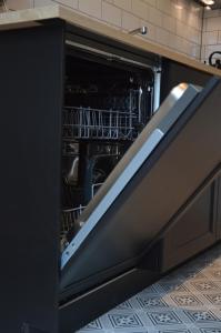 a dishwasher with its door open in a kitchen at Cosy Casa in Egmond aan Zee
