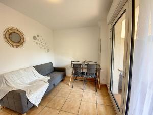 a living room with a couch and a table at L'orangeraie du Cap d'Antibes in Antibes