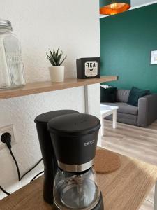 a coffee maker sitting on a counter in a living room at Cityapartment in Stadtlohn