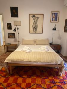 a bedroom with a bed with two towels on it at Salasco 20 - Bocconi Porta Romana stylish apt! Self Check- In in Milan