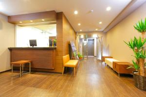 a lobby of an office with benches and plants at HOTEL MYSTAYS Ueno Iriyaguchi in Tokyo