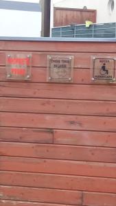 a wooden garage door with two signs on it at L'escale N°13 :Appartement standing dans résidence in Brest