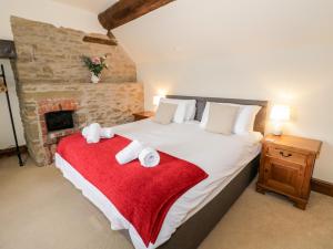 Ένα ή περισσότερα κρεβάτια σε δωμάτιο στο Wilstone Cottage