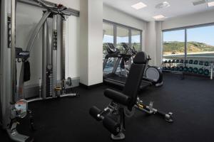 a gym with two treadmills and machines in a room at Rydges Wellington Airport in Wellington