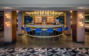 a bar in a hotel lobby with blue chairs at YOTEL Edinburgh in Edinburgh