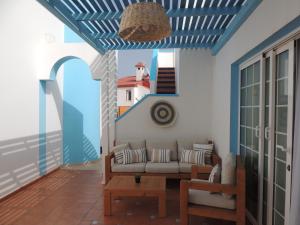 A seating area at COZY, Beach House , by MAHBOVILLAS