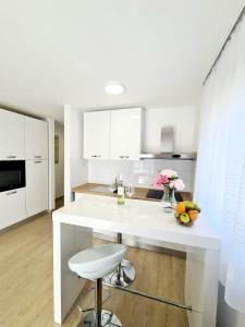 a white kitchen with a white island in a room at Apartment Ane 3 in Tisno