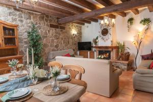 ein Wohnzimmer mit Tisch und Stühlen und einem Kamin in der Unterkunft El Pajar de Trescasas in Sonsoto