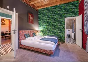 a bedroom with a large bed with a green wall at Rezydencja Julin Slow Life dla Gości 16+ in Wydrze