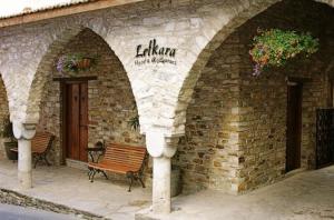 a building with a bench in front of it at Lefkara Hotel in Pano Lefkara