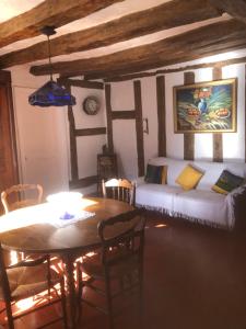a living room with a bed and a table with a dining room at La Vigne dorée in Saint-Martin-des-Champs