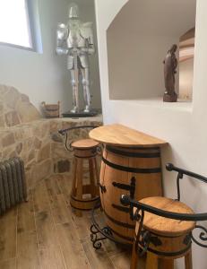 a room with a table and two stools at SUPERB - Medieval apartment in Kutná Hora