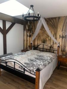 a bedroom with a bed with a canopy at SUPERB - Medieval apartment in Kutná Hora