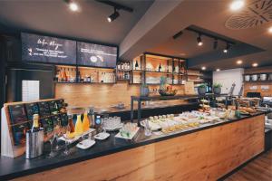 a restaurant with a counter with food on it at Hotel Hanauerhof in Appenweier