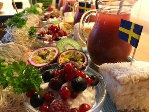 a table topped with bowls of food and a pot of tea at Haere Mai B&B Orust in Henån