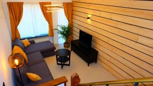 a living room with a couch and a fireplace at La Tanière des Loups in Herbeumont