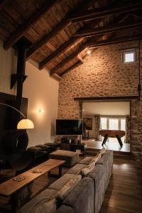 a living room with a couch and a table at La Maison des Champs in Saint-Agrève