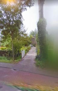 a road leading to a house with a white fence at Landgoed de Bongel in De Wijk +3 photos