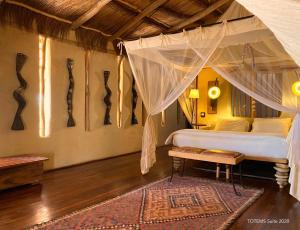 A bed or beds in a room at Bakuba Lodge - Le petit hôtel du Voyageur